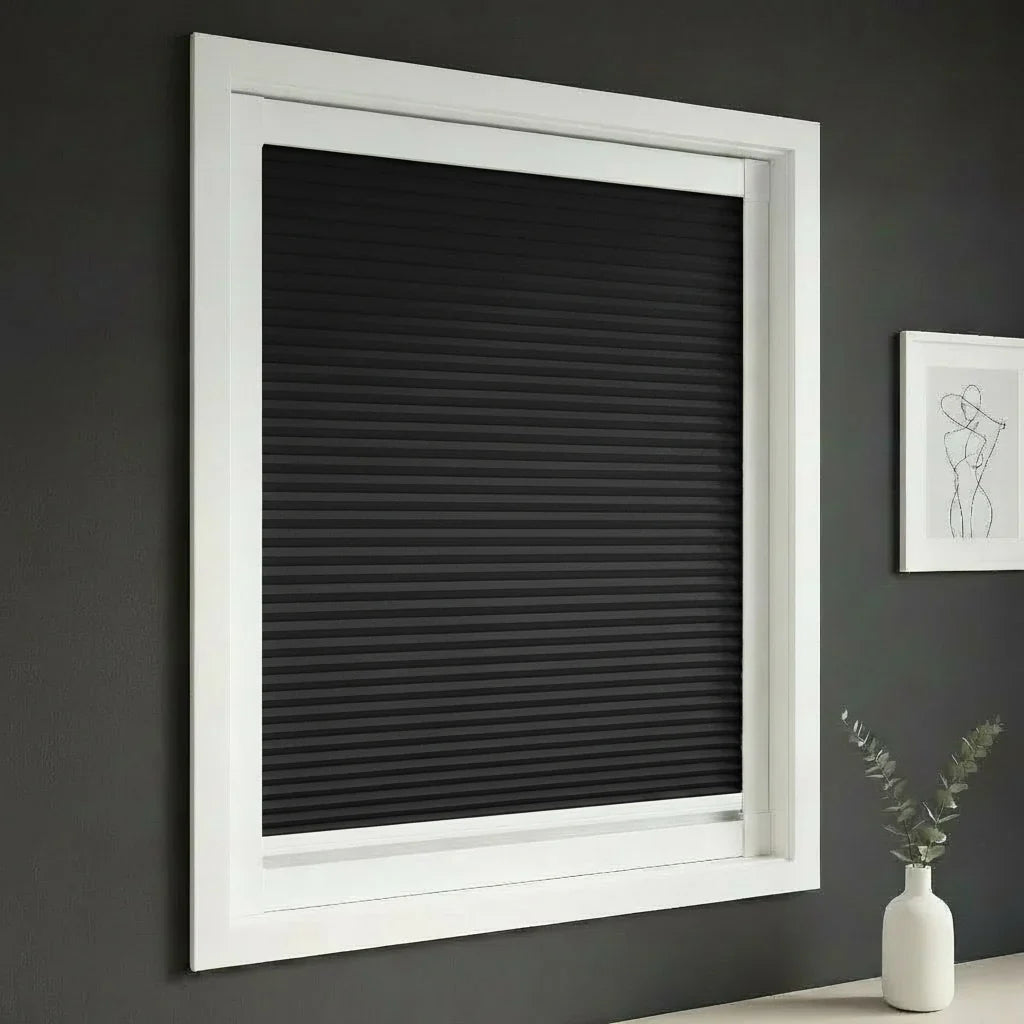 FAIZ blackout cellular blind in Black fabric with White rail, shown for nighttime privacy and restful sleep.