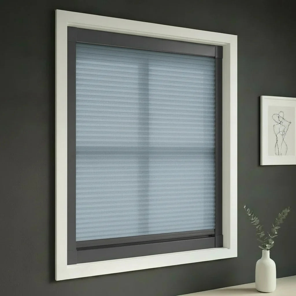 FAIZ light filtering cellular blind in Blue fabric with Dark Grey rail, shown for balanced daylight in a restful interior.