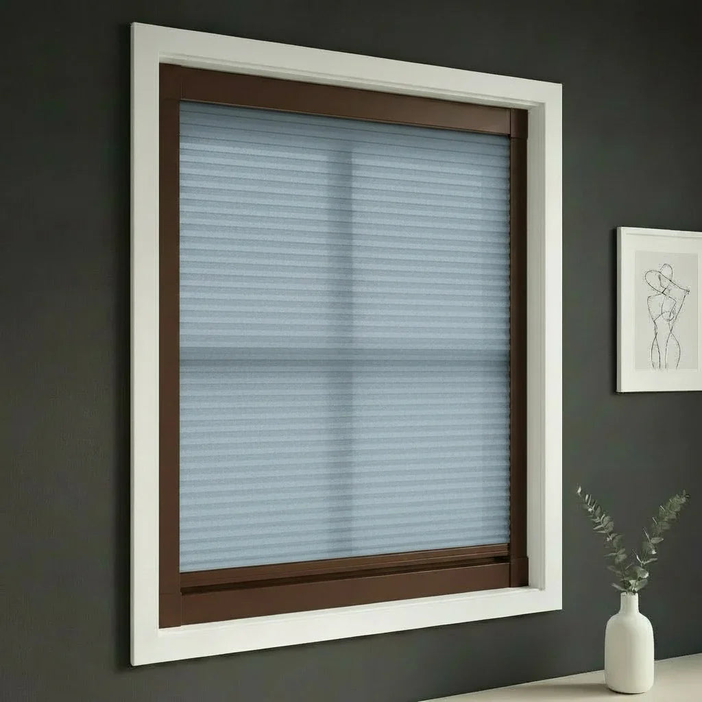 FAIZ light filtering cellular blind in Blue fabric with Coffee Brown rail, shown for gentle everyday light in a family home.