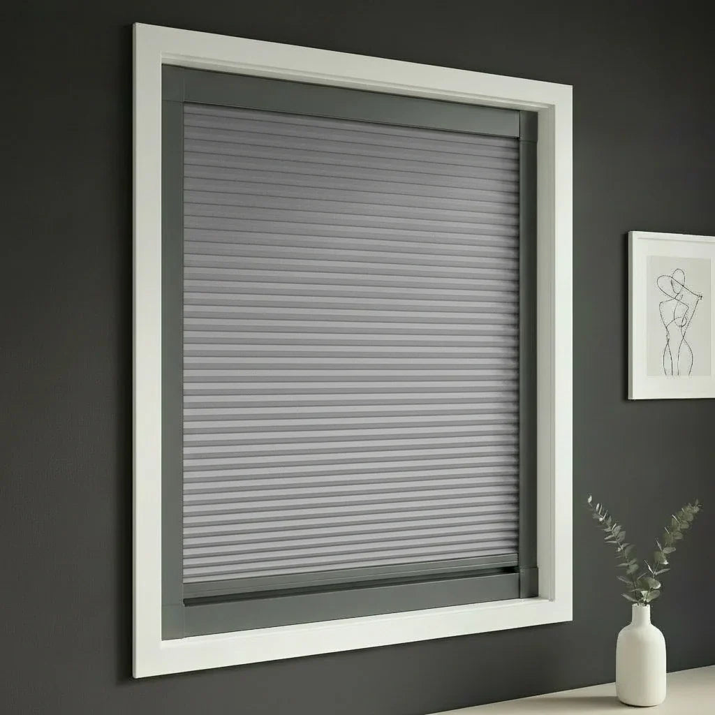FAIZ blackout cellular blind in Dark Grey fabric with Dark Grey rail, shown to support sleep quality in a darker room.