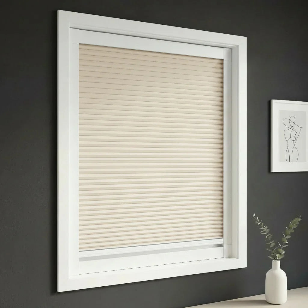 FAIZ blackout cellular blind in Light Khaki fabric with White rail, shown for complete darkness and uninterrupted rest.