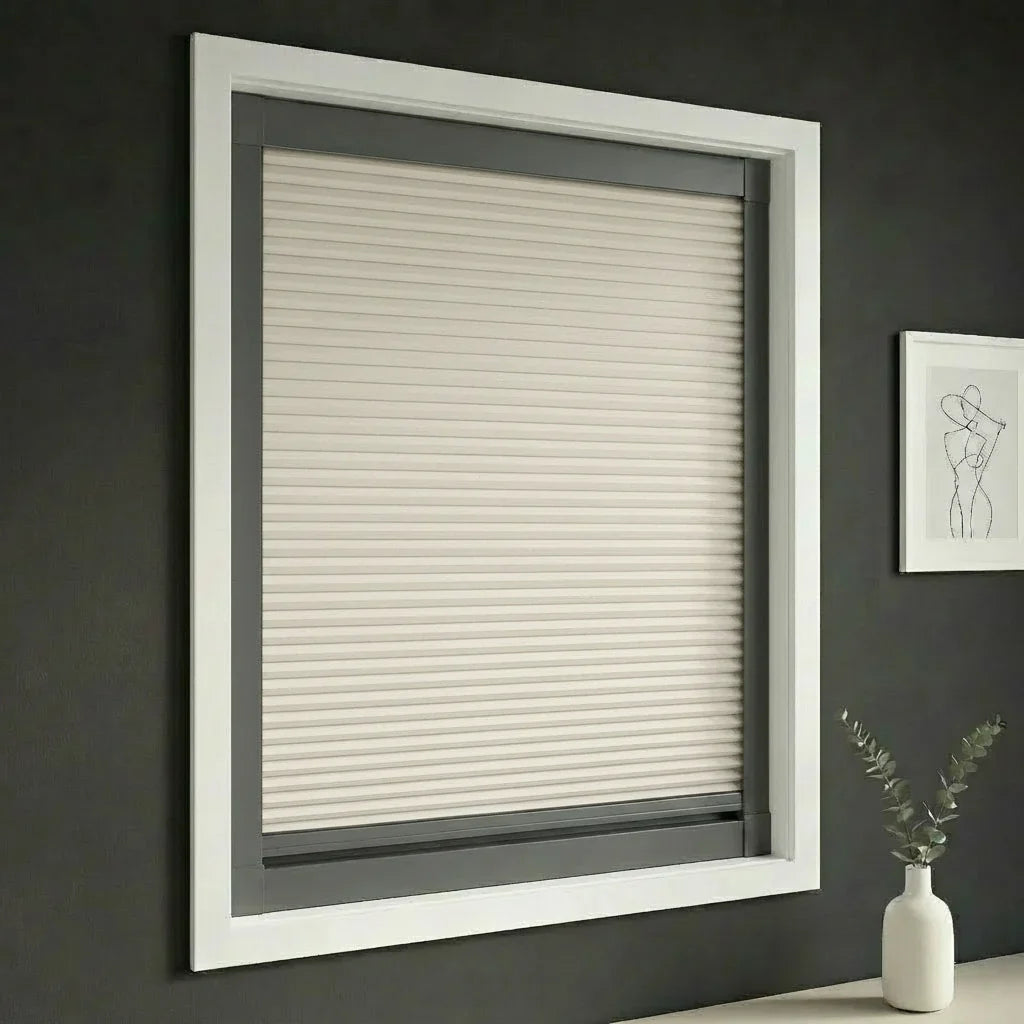 FAIZ blackout cellular blind in Light Khaki fabric with Dark Grey rail, shown for comfortable nighttime sleep.