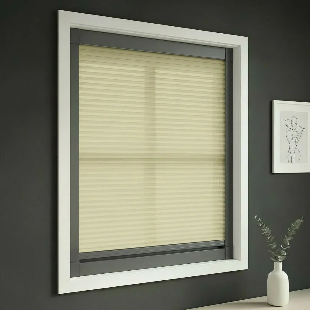 FAIZ light filtering cellular blind in Light Khaki fabric with Dark Grey rail, shown for privacy with softly filtered daylight.