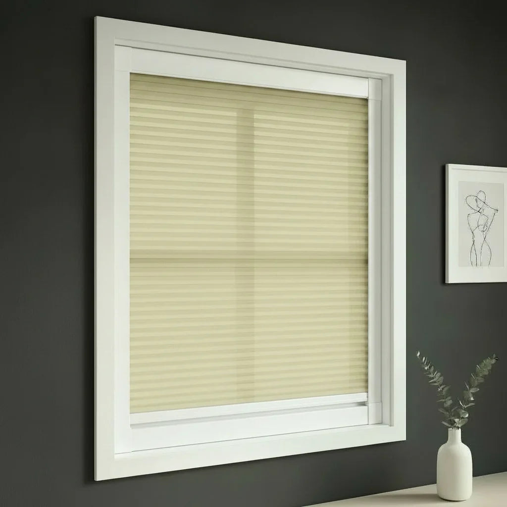 FAIZ light filtering cellular blind in Light Khaki fabric with White rail, shown for a restful living-room ambience.