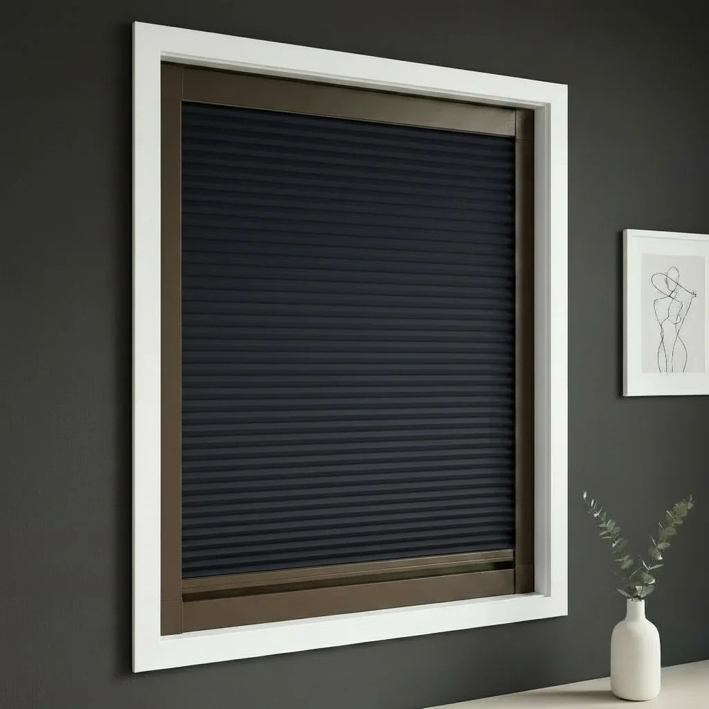 FAIZ blackout cellular blind in Navy Blue fabric with Coffee Brown rail, shown for a wellness-focused bedroom and better rest.