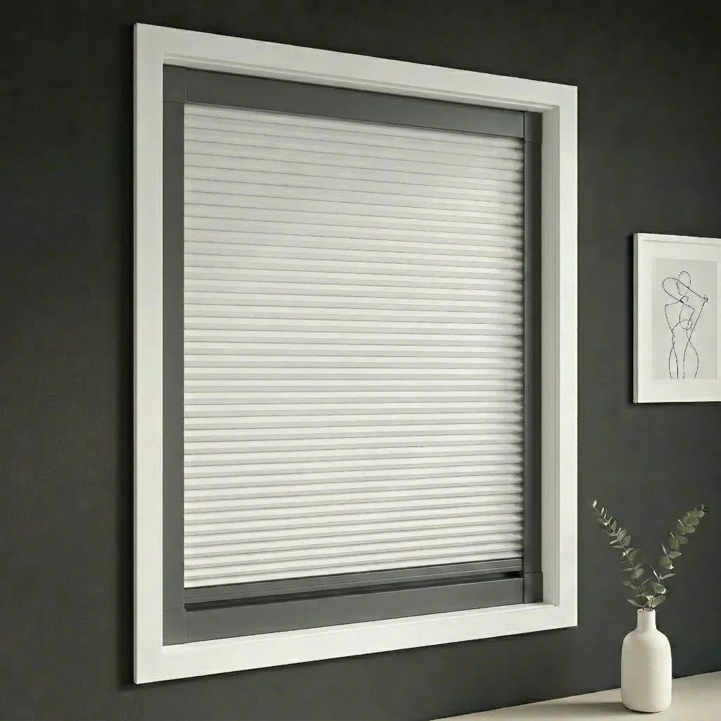 FAIZ blackout cellular blind in Pure White fabric with Dark Grey rail, shown for a darker bedroom designed for deeper sleep.