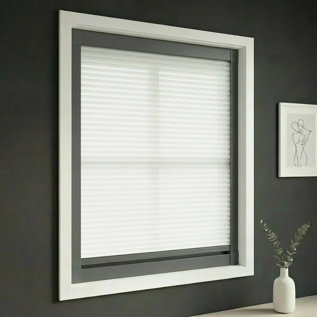FAIZ light filtering cellular blind in White fabric with Dark Grey rail, shown for gentle glare control in a modern home.